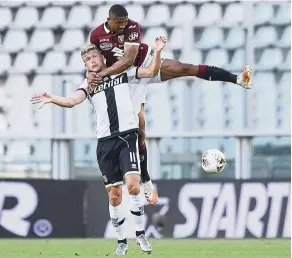  ??  ?? Going all out: Torino’s nicolas nkoulou (top) vying for the ball with Parma’s andreas Cornelius during the Serie a match on Saturday. — AP