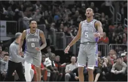  ?? AP file photo ?? The Kings’ De’Aaron Fox (right) celebrates scoring with Malik Monk during a game against the Bulls on March 15.