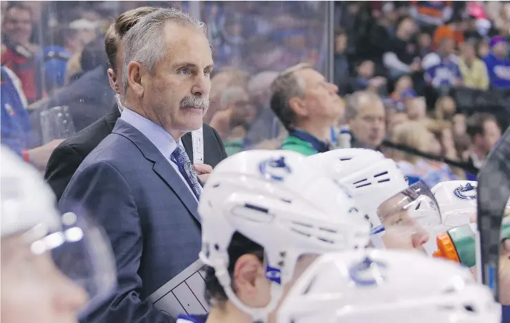  ?? — GETTY IMAGES FILES ?? Head coach Willie Desjardins has a math problem as the Canucks head out on a six-game road trip: nine defencemen, three too many for the lineup.
