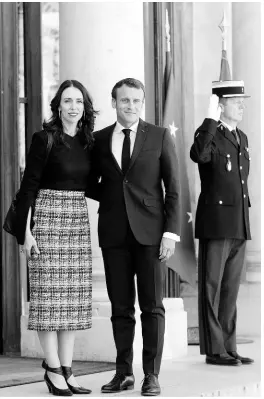  ?? AP ?? New Zealand Prime Minister Jacinda Ardern (left) is greeted by French President Emmanuel Macron (centre) as she arrives at the Elysee Palace in Paris recently. World leaders and tech bosses are meeting in Paris to discuss ways to prevent social media from spreading deadly ideas.