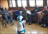  ?? LI SHENGLI AND SHI JIANXUE / FOR CHINA DAILY ?? (Left) A boy interacts with a robot at a fair in Tianjin. (Right) robot at an elderly home in Hangzhou, Zhejiang province. older people interact with companion