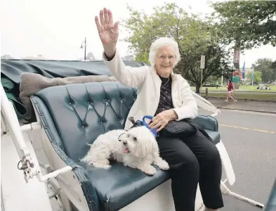  ?? DARREN STONE, TIMES COLONIST ?? Gladys Sweett celebrates her 100th birthday on Wednesday with her newly acquired rescue dog, Maggie, during a horsedrawn carriage ride in Victoria. Sweett is part of the 100-plus crowd, Canada’s fastest-growing demographi­c. Consider this: Half of all...