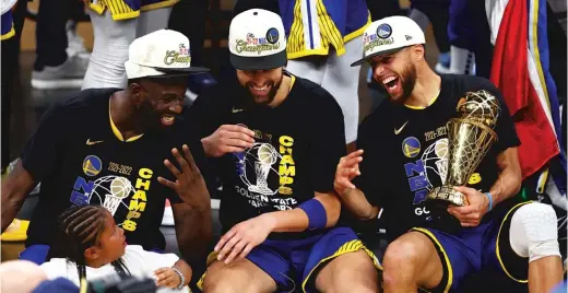  ?? GETTY IMAGES ?? Warriors stars Draymond Green (from left), Klay Thompson and Stephen Curry share a laugh after winning their fourth NBA Finals in the last eight seasons.