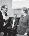  ?? John MacDougall / AFP via Getty Images ?? Alexander Dobrindt, leader of the CSU parliament­ary group, greets German Chancellor Angela Merkel in a Buddhist style to avoid a handshake.