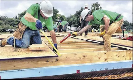  ?? SALTWIRE NETWORK ?? Volunteers working on a Habitat for Humanity build day in Oxford. The second home in Oxford will be turned over to its new owners in May.