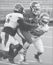  ?? Fred Conley • Times-Herald ?? A Blue squad Forrest City running back splits a pair of White defenders in a preseason Blue-White scrimmage game played last Friday at Sam Smith Stadium.