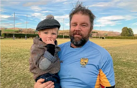  ?? RACHAEL KELLY/STUFF ?? James McKee, with his son Ben, after playing 350 games for the Waikaia Rugby Club.