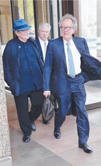  ?? Picture: RICHARD DOBSON ?? Geoffrey Rush and director Fred Schepisi (blue hat) at the Supreme Court in Sydney for the fifth day of the hearing into alleged sexual assault by Mr Rush on a fellow actor.