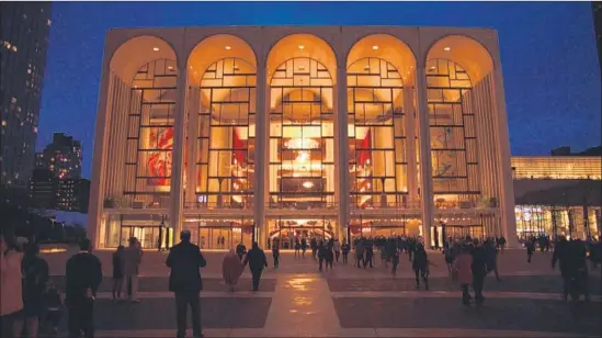  ?? Metropolit­an Opera ?? THE MET’S opera house is brilliantl­y lighted for a performanc­e in 2017. The house opened in New York’s Lincoln Center in 1966 and has been drawing fans ever since.