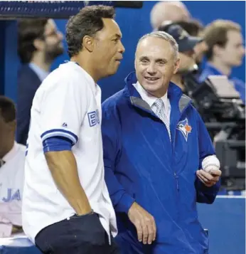  ?? PETER POWER/THE CANADIAN PRESS ?? Commission­er Rob Manfred, right, with Hall of Famer Roberto Alomar, attends his first Blue Jays game in Toronto.