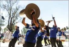  ??  ?? Cymbalist Melanie Murillo, 12, (middle) performs with the Heber Hawks Drumline during the city of El Centro’s 110th anniversar­y celebratio­n at Bucklin Park in El Centro. VINCENT OSUNA PHOTO