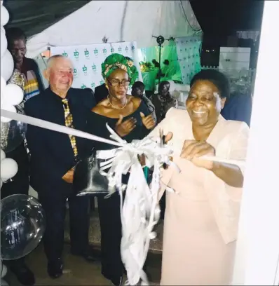  ?? ?? Bulawayo Metropolit­an Affairs minister Judith Ncube (right) cuts the ribbon as she officially opens the ZB Bank Belmont service centre on Saturday