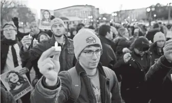  ?? WIN MCNAMEE/GETTY IMAGES ?? Protesters advocating the DREAM Act hold a candleligh­t vigil outside the U.S. Capitol on Jan. 18.