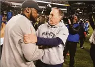  ?? Don Wright / Associated Press ?? Pittsburgh Steelers coach Mike Tomlin, left, and New England Patriots coach Bill Belichick talk on the field following a game in Pittsburgh in 2018.