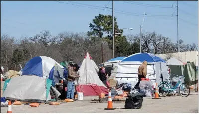  ?? (Los Angeles Times/Molly Hennessy-Fiske) ?? About 100 people are housed at Austin’s state-run camp for the homeless. A self-appointed seven-member committee of residents has dubbed it Camp Responsibl­e Adult Transition Town, or Camp RATT.