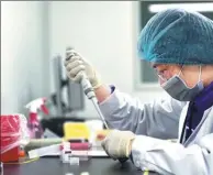  ?? HUANG ZONGZHI / XINHUA ?? A scientist conducts tests for 1GENE, a genetic testing company in Hangzhou, Zhejiang province.
