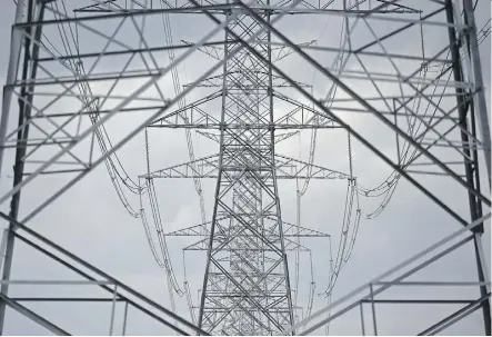  ?? JOHN LUCAS/FILE ?? High tension power lines along the southeast Henday. Alberta has massively overbuilt the electrical transmissi­on system, resulting in huge costs, says a report from a ratepayer coalition.