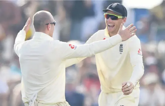  ?? Picture: Stu Forster/Getty Images ?? England bowler Jack Leach, left, congratula­tes Jos Buttler after the pair combined to dismiss Sri Lanka batsman Diruwan Perera