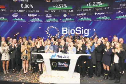  ?? Hearst Connecticu­t Media file photo ?? Ken Londoner, center, and staff of his Westport-based BioSig Technologi­es during a September 2018 ceremony commemorat­ing the company’s trading debut on the Nasdaq.