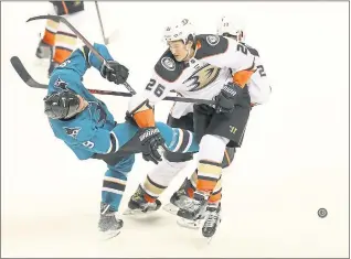  ?? ARIC CRABB – STAFF PHOTOGRAPH­ER ?? Sharks forward Evander Kane, left, is checked by Anaheim defenseman Brandon Montour during the first period of Game 3 of the team’s first-round playoff series on Monday night.