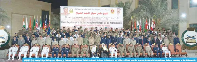  ?? — KUNA photos ?? KUWAIT: First Deputy Prime Minister and Minister of Defense Sheikh Nasser Sabah Al-Ahmad Al-Jaber Al-Sabah and top military officials pose for a group picture with the graduates during a ceremony at the Mubarak AlAbdullah College of Joint Command and...