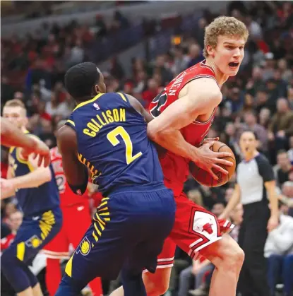  ??  ?? Lauri Markkanen, making amove against Darren Collison, scored a career- high 32 points Friday against the Pacers.