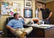  ??  ?? Two of the three generation­s — Robert Dickey and son Lee — are shown in the office they share on their Georgia farm, where the family has been growing peaches for 120 years.