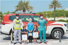  ?? ?? The three Syrian siblings with Ajman Police officials after receiving their treats.