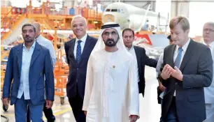  ?? — Wam ?? Sheikh Mohammed bin Rashid Al Maktoum and Sheikh Ahmed bin Saeed Al Maktoum tour an Airbus plant in Hamburg on Monday. They are briefed by senior Airbus executives.