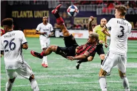  ?? CURTIS COMPTON / CCOMPTON@AJC.COM ?? United forward Josef Martinez’s bicycle kick between Philadelph­ia’s Auston Trusty and Jack Elliott was blocked by goalkeeper Andre Blake on March 17.