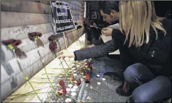  ?? EMRAH GUREL / ASSOCIATED PRESS ?? People leave carnations near the scene of an explosion in the city’s landmark Taksim Square in Istanbul, Turkey, on Saturday. The suicide bomb attack killed a number of people and injured over a dozen others.