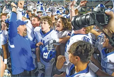  ?? GREG Davis/special to The Saline Courier ?? Bryant Hornets Coach Buck James, left, celebrates with his Bryant Hornets after defeating the Fayettevil­le Purple Dogs 42-38 Saturday night at War Memorial Stadium in Little Rock. It was James’ and Bryant’s fourth straight state title.