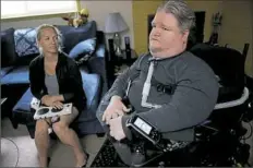  ?? Pam Panchak/Post-Gazette ?? Steven Spohn, COO of The AbleGamers Charity, and his friend Ronelle Clutter demonstrat­e how the Xbox Adaptive Controller is used in Mr. Spohn’s home in Upper St. Clair.