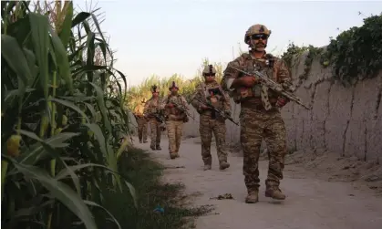  ?? ?? Afghan special forces patrol during an operation against Taliban militants in October 2019, inHelmand province. Photograph: Watan Yar/ EPA