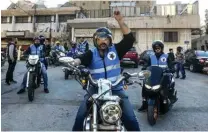  ?? ?? Members of motorcycle club Hope Bikers Syria help distribute “iftar” fast breaking meals during the Muslim holy fasting month of Ramadan, in Damascus.