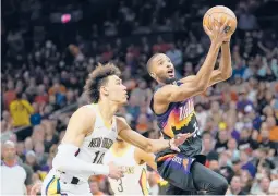  ?? MATT YORK/AP ?? Mikal Bridges drives past Jaxson Hayes during the Suns’ 112-97 victory over the Pelicans on Tuesday in Game 5 of their Western Conference first-round playoff series.