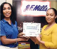  ??  ?? Donna-Kaye Sharpe (left), trading marketing and distributi­on manager at J.F. Mills, presents Jannelle Garcia, human resources manager at Golden Loaf Bakery, with the first-place prize.