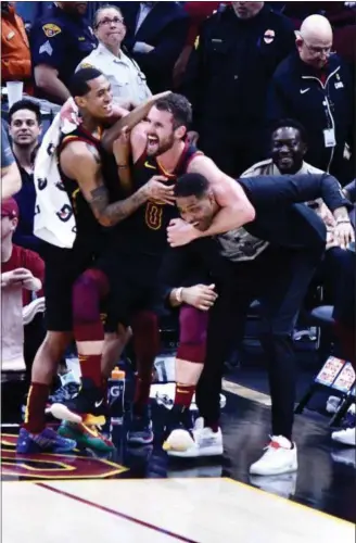  ?? PAUL DICICCO — FOR THE NEWS-HERALD ?? Jordan Clarkson, Kevin Love and Tristan Thompson celebrate during the Cavaliers’ victory over Raptors on March 11 at Quicken Loans Arena.