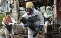  ?? KIMIMASA MAYAMA, THE ASSOCIATED PRESS ?? July 2014: Workers handle pipes used to create a frozen undergroun­d wall at the Fukushima power plant northeast of Tokyo.