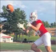  ?? MIKE DRAGO — READING EAGLE ?? Wilson’s Corey Powers, normally a tight end and linebacker, throws a 21-yard touchdown pass in the Bulldogs’ win over Hempfield.