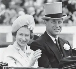  ?? AP ?? In this June 19, 1962 file photo, Britain’s Prince Philip and his wife Queen Elizabeth II arrive at Royal Ascot race meeting, England. Britain’s Prince Philip stood loyally behind behind Queen Elizabeth, as his character does on Netflix’s “The Crown.” But how closely does the TV character match the real prince, who died April 9 at 99?