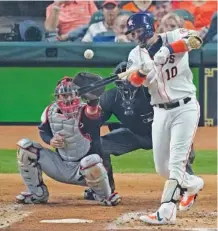 ?? AP PHOTO/ERIC GAY ?? The Houston Astros’ Yuli Gurriel hits a two-run double during the first inning of Game 1 of the World Series against the Washington Nationals on Tuesday in Houston. See timesfreep­ress.com for coverage of the late game.