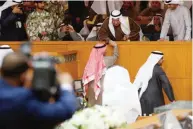  ??  ?? Marzouq Al-Ghanem shakes his father Ali Thunaiyan Al-Ghanem’s hand after being elected as speaker.