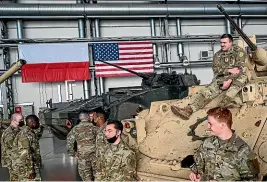  ?? GETTY IMAGES ?? US and Polish soldiers socialise after the Americans arrived at a Polish air base in Powidz as part of Nato’s buildup of forces in response to the crisis at the Russia-Ukraine border. Russia accuses Western powers of breaking promises about Nato expansion.