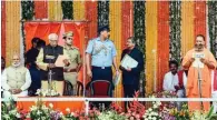  ?? - PTI ?? SWEARING-IN CEREMONY: Governor Ram Naik administer­s oath of office and secrecy to the new UP Chief Minister Yogi Adityanath at the swearing-in ceremony in Lucknow on Sunday.