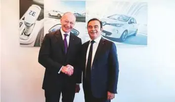  ?? Bloomberg ?? ■ Thierry Bollore, chief competitiv­e officer of Renault SA (left), and Carlos Ghosn, chairman of Renault SA, pose for a photograph following a news conference in Paris in February.