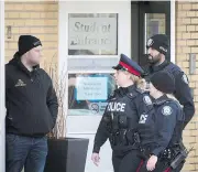  ?? TIJANA MARTIN / THE CANADIAN PRESS ?? Toronto police respond to a bomb threat at St. Michael’s College School in Toronto on Monday, on the same day that six teens from the all-boys private school were charged in connection with an alleged gang sexual assault.