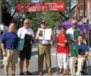  ?? SUBMITTED PHOTO ?? State Sen. Andy Dinniman, third from left, presents a citation to Laurel Valley Soils during the opening ceremony of the Mushroom Festival on Saturday morning.