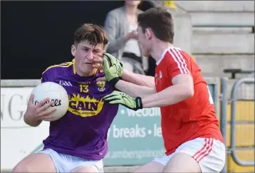  ??  ?? Wexford free-taker Jamie Myler under pressure from Louth defender Dan Corcoran.