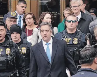  ?? CHANG W. LEE NEW YORK TIMES ?? Michael Cohen, centre, leaves federal court after his sentencing in Manhattan. He had told the judge: “It was my own weakness and a blind loyalty to this man (Trump) that led me to choose a path of darkness over light.”